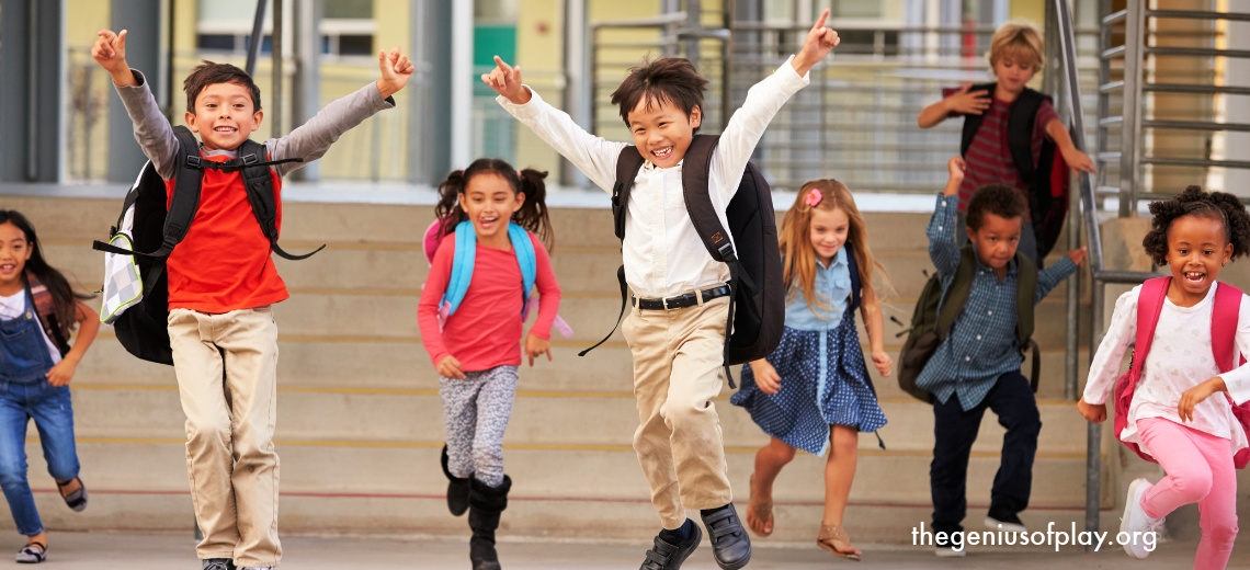 multi racial school aged kids running and smiling in a school hallway