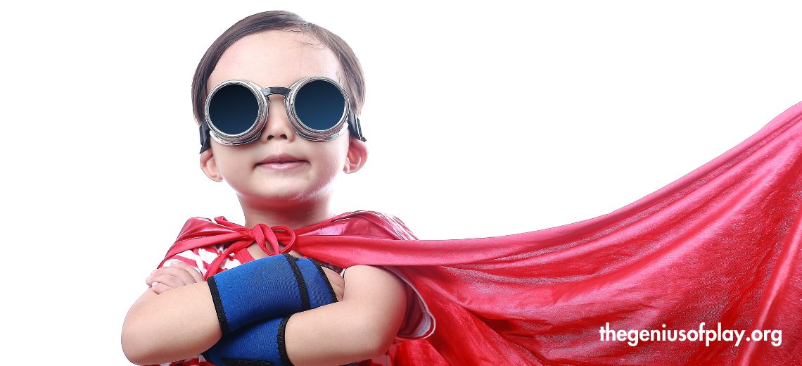 elementary aged child standing in a power pose wearing a superhero costume 