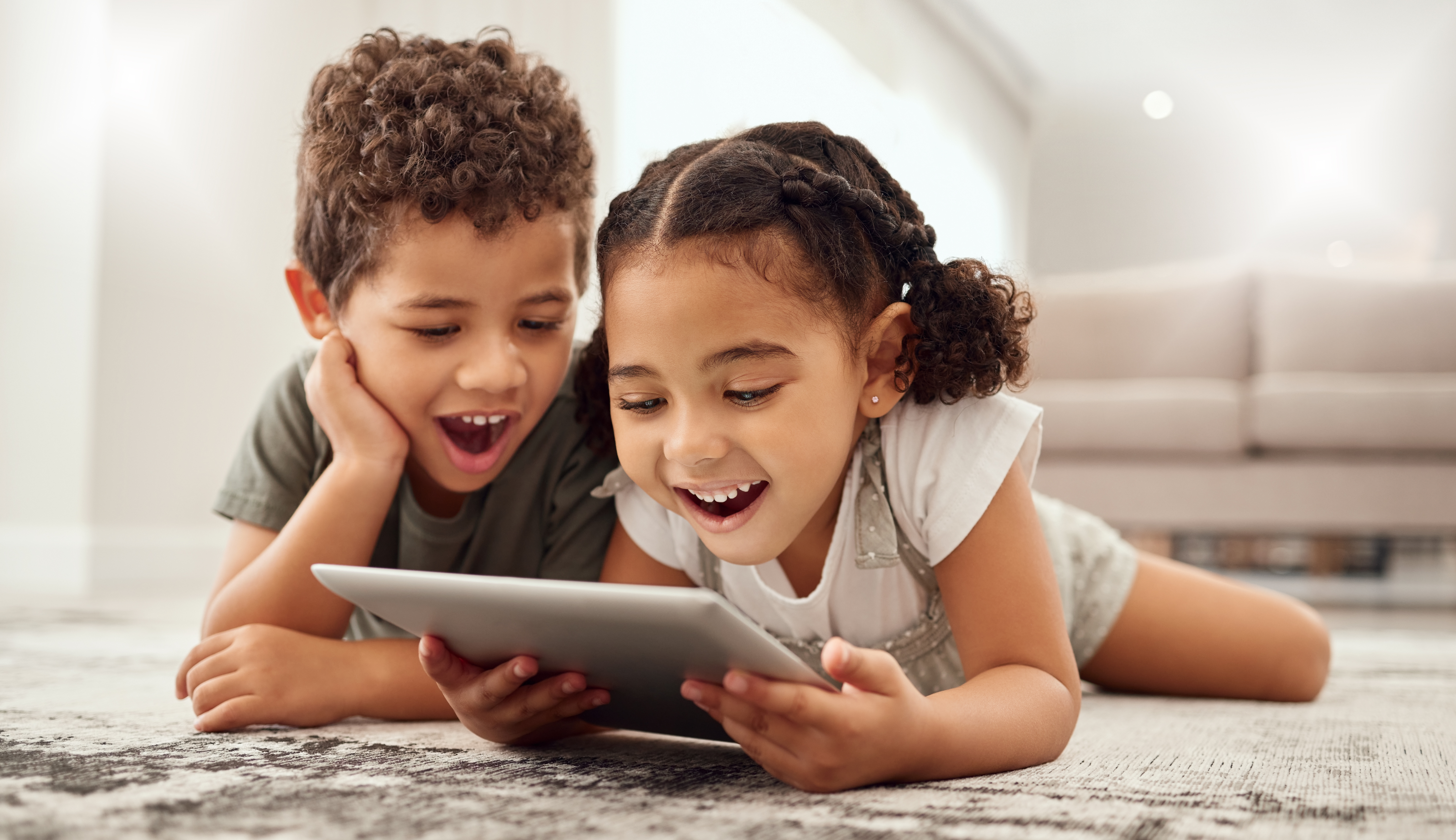 two kids watching content on a tablet