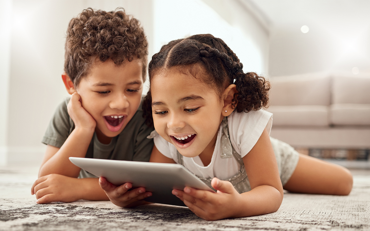 two kids watching a tablet
