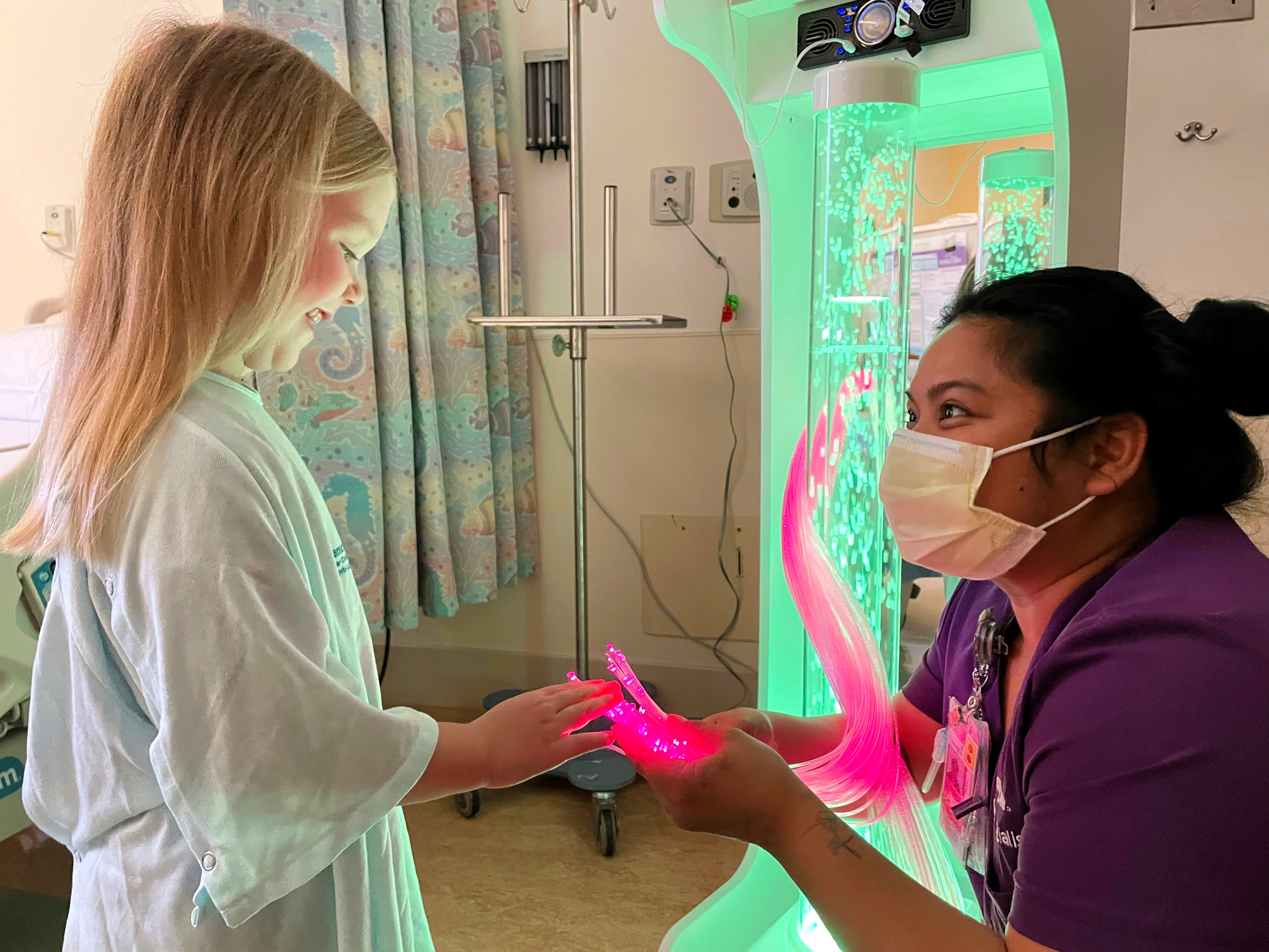 patient in children's hospital playing with sensory toy